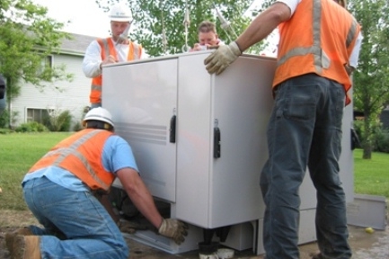 Installation of pad-mount FlexSure FLX16RS delivering triple-play service to neighborhoods