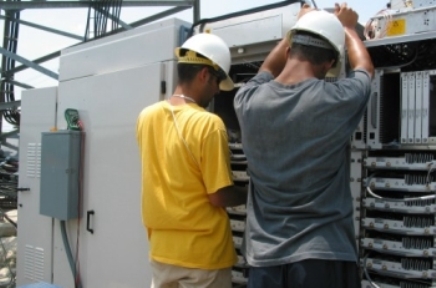 Purcell Systems field service experts inspect an outdoor equipment enclosure